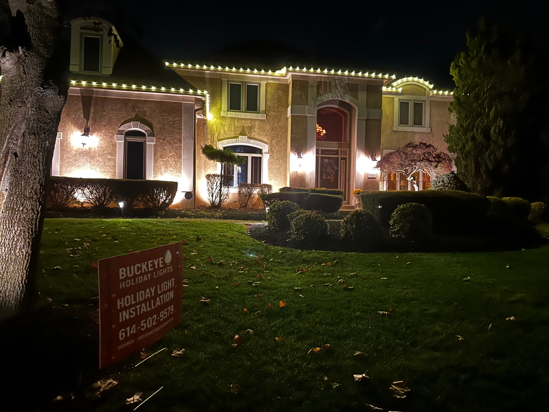 Central Ohio home installed by Buckeye Holiday Lights, outlined with warm white C9 Christmas lights at night